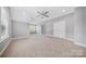 Spacious bedroom with neutral gray walls, a ceiling fan, and natural light from a window at 8169 Clems Branch Rd, Indian Land, SC 29707