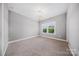 Neutral bedroom features carpet, overhead lighting, and large windows at 8169 Clems Branch Rd, Indian Land, SC 29707