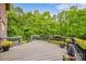 View of the wooden deck adorned with flower pots overlooking a lush green backyard at 8169 Clems Branch Rd, Indian Land, SC 29707