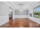Bright dining area with hardwood floors, stainless steel fridge, tray ceiling, and large window at 8169 Clems Branch Rd, Indian Land, SC 29707