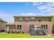 Brick home featuring a well-maintained lawn, a deck, and mature trees in the backyard at 8169 Clems Branch Rd, Indian Land, SC 29707
