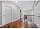 Upstairs hallway featuring hardwood floors, white trim and walls, and natural lighting at 8169 Clems Branch Rd, Indian Land, SC 29707