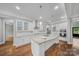 Bright, modern kitchen with a center island, white cabinets, and stainless steel appliances at 8169 Clems Branch Rd, Indian Land, SC 29707