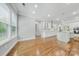 Sunlit living area boasting hardwood floors and an open-concept design into the modern kitchen at 8169 Clems Branch Rd, Indian Land, SC 29707