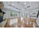 Spacious living room features a stone fireplace, hardwood floors, and coffered ceiling at 8169 Clems Branch Rd, Indian Land, SC 29707