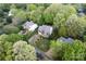 Lovely aerial view of a two-story home showcasing mature trees, well-manicured lawn, and a curved street in a quiet neighborhood at 9009 Tayside Ct, Huntersville, NC 28078