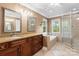 Bathroom with double sinks, granite countertops, shower, and garden tub at 9009 Tayside Ct, Huntersville, NC 28078