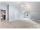 Expansive bonus room with soft carpet, featuring a door and a window at 9009 Tayside Ct, Huntersville, NC 28078