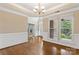 Dining room with hardwood flooring and large windows overlooking the front yard at 9009 Tayside Ct, Huntersville, NC 28078