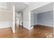 Spacious entryway featuring hardwood floors, elegant molding, and a view of a room through glass paned french doors at 9009 Tayside Ct, Huntersville, NC 28078