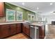 Functional kitchen showcases wooden cabinetry, countertops, stainless steel appliances, and an adjacent living space at 9009 Tayside Ct, Huntersville, NC 28078