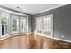 Bright living room with hardwood floors, bay window, and white french doors at 9009 Tayside Ct, Huntersville, NC 28078