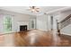 Inviting living room showcasing hardwood floors, large windows, a fireplace, and a staircase at 9009 Tayside Ct, Huntersville, NC 28078