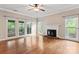 Bright living room boasts hardwood floors, a cozy fireplace, large windows, and a view of the back porch at 9009 Tayside Ct, Huntersville, NC 28078