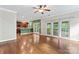 Open living room layout with hardwood floors, screened porch access, and connection to the kitchen and dining area at 9009 Tayside Ct, Huntersville, NC 28078