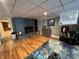 Finished basement with gray painted brick fireplace and access to an unfinished area at 901 Ridge St, Albemarle, NC 28001