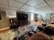 Basement media room with large TV, reclining chairs, and laminate floors at 901 Ridge St, Albemarle, NC 28001