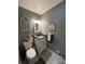 Cozy bathroom featuring gray walls, decorative bunnies, patterned floors, and a single vanity at 901 Ridge St, Albemarle, NC 28001