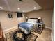 Bedroom with neutral walls, patterned bedding, tiled flooring, and a black decorative rug at 901 Ridge St, Albemarle, NC 28001