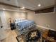 Charming bedroom featuring tan walls, patterned bedding, a dark rug, and tiled flooring at 901 Ridge St, Albemarle, NC 28001