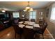 Elegant dining room with natural light, hardwood floors, and a classic chandelier at 901 Ridge St, Albemarle, NC 28001