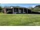 Charming brick home with a manicured lawn and white pillars accenting the front entrance at 901 Ridge St, Albemarle, NC 28001
