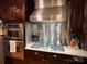 Well-equipped kitchen with stainless steel range hood, oven, and granite countertops at 901 Ridge St, Albemarle, NC 28001