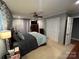 Well-lit bedroom with neutral tones, a ceiling fan, and closet space at 901 Ridge St, Albemarle, NC 28001