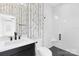Bright bathroom with white subway tile shower, dark fixtures, and decorative wallpaper adds a touch of style at 9020 Tynecastle Commons Ct, Charlotte, NC 28226