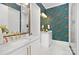 Chic bathroom features dual marble vanities with gold hardware and fixtures and fish themed wallpaper at 9020 Tynecastle Commons Ct, Charlotte, NC 28226