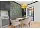 Cozy dining nook with a stylish chandelier, banquette seating, and a beverage refrigerator at 9020 Tynecastle Commons Ct, Charlotte, NC 28226