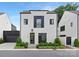 Modern white two-story house with black framed windows, manicured landscaping, and an attached garage at 9020 Tynecastle Commons Ct, Charlotte, NC 28226
