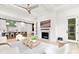 Open-concept living room with fireplace flows into a modern kitchen with white cabinets and a large island at 9020 Tynecastle Commons Ct, Charlotte, NC 28226