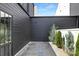This outdoor patio features slate tile, modern trees and a cedar plank fence providing a private entertaining space at 9020 Tynecastle Commons Ct, Charlotte, NC 28226
