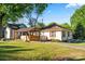 Spacious backyard with a covered patio and mature trees providing shade at 912 W A St, Kannapolis, NC 28081