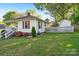 Well-maintained front yard with fresh green lawn, colorful flowerbeds and bright red shutters at 912 W A St, Kannapolis, NC 28081