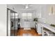 Modern kitchen with white cabinets, stainless steel appliances, and hardwood floors at 912 W A St, Kannapolis, NC 28081
