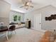 Light and airy bedroom featuring a window seat, built-ins, and a ceiling fan at 100 Verbena Ct, Weddington, NC 28173