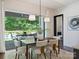 Bright dining room with hardwood floors and large sliding doors leading to the backyard and outdoor dining area at 100 Verbena Ct, Weddington, NC 28173