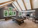 Spacious game room with pool table, vaulted ceilings, bar area, and wall of windows at 100 Verbena Ct, Weddington, NC 28173