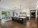 Modern kitchen features a spacious island, barstool seating, stainless appliances, and open access to the dining area at 100 Verbena Ct, Weddington, NC 28173