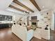 Bright and spacious living room with fireplace, wood beams, and seamless access to the kitchen and staircase at 100 Verbena Ct, Weddington, NC 28173