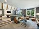 Inviting living room in gray tones featuring a pool table, sofa, and comfortable chairs at 100 Verbena Ct, Weddington, NC 28173