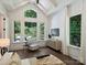 Main bedroom featuring hardwood floors, backyard view, and a comfortable seating area at 100 Verbena Ct, Weddington, NC 28173