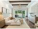 Main bedroom suite with wooden floors, pool view, chandelier, and elegant decor at 100 Verbena Ct, Weddington, NC 28173