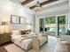 Main bedroom suite with pool views, wooden beams, chandelier, and a bench seat at 100 Verbena Ct, Weddington, NC 28173