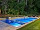 Stunning pool illuminated at night, featuring a spa, water features, and inviting lounge area at 100 Verbena Ct, Weddington, NC 28173