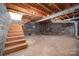 Unfinished basement with block walls, exposed wood ceiling, and concrete floor ready for customization at 1012 Hawkinstown Rd, Salisbury, NC 28144