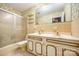 Full bathroom with double sinks, tile flooring, and tub-shower combo at 1012 Hawkinstown Rd, Salisbury, NC 28144