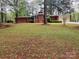 Lovely red brick home with a well-manicured lawn and blossoming trees at 1012 Hawkinstown Rd, Salisbury, NC 28144